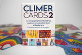 Climer Cards 2 deck with 52 watercolor image cards and emotion words in English, Spanish, and French, in a durable cardboard box.