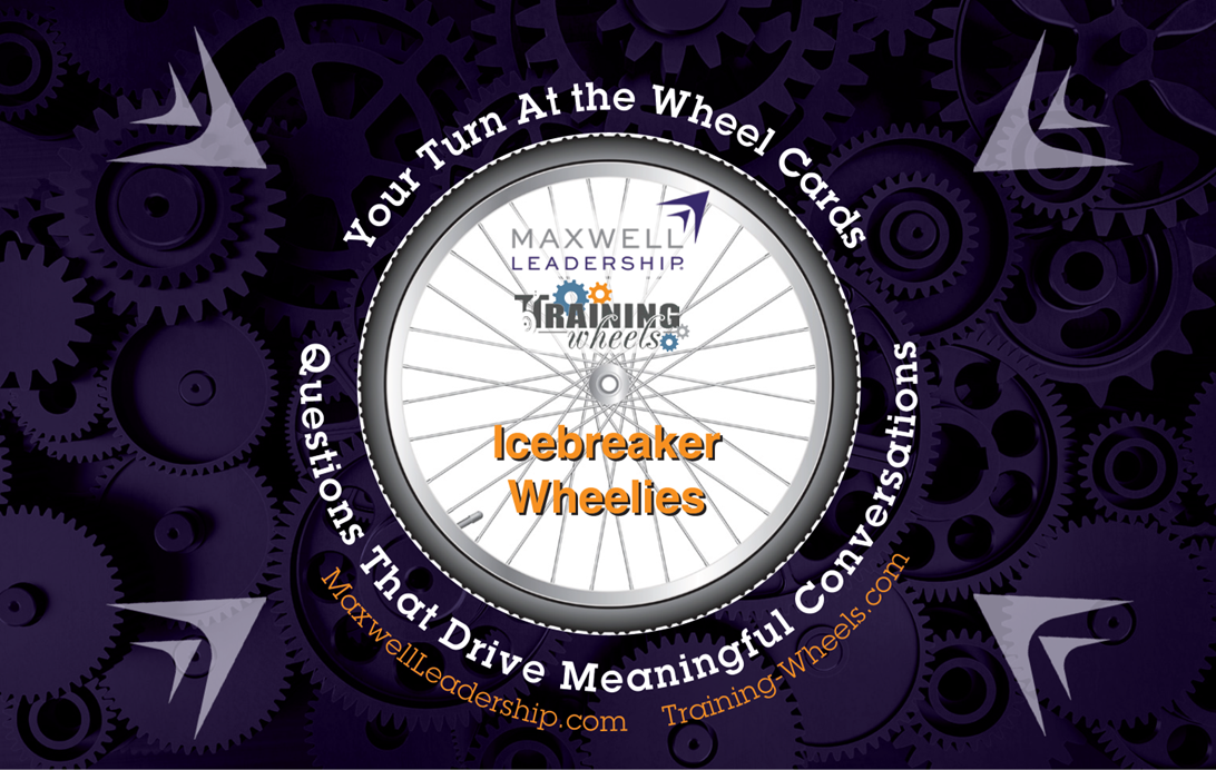 A set of Maxwell Leadership Icebreaker Wheelie Cards displayed in a stylish tin, with participants exchanging cards and sharing responses in a group setting.