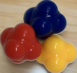 A brightly colored, odd-shaped Ricochet Ball ready for group games and reaction skill activities.
