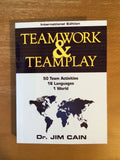 Cover of Teamwork & Teamplay International Edition by Dr. Jim Cain, featuring a globe and multilingual activity icons.