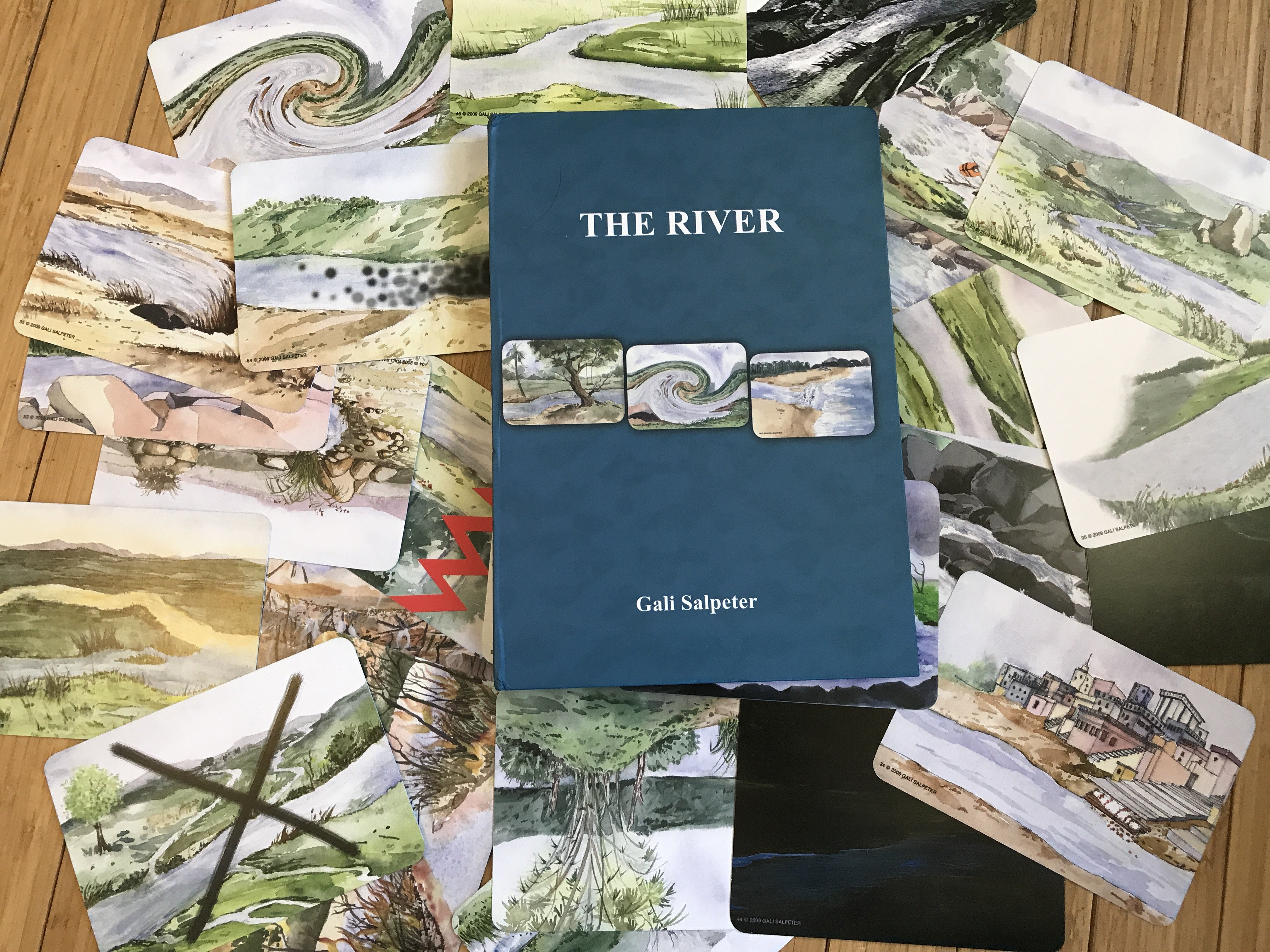 A spread of The River Cards featuring symbolic river imagery, used by therapists for individual and group therapy sessions.