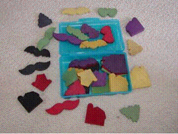 Blind Shapes activity set with colorful hand-dyed wooden shapes, nylon bag, and instruction sheet for group diversity and curiosity activities.