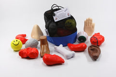 Body Part Debrief sets with colorful stress balls shaped like body parts, mesh stuff sack, and instruction guide for group reflection activities.