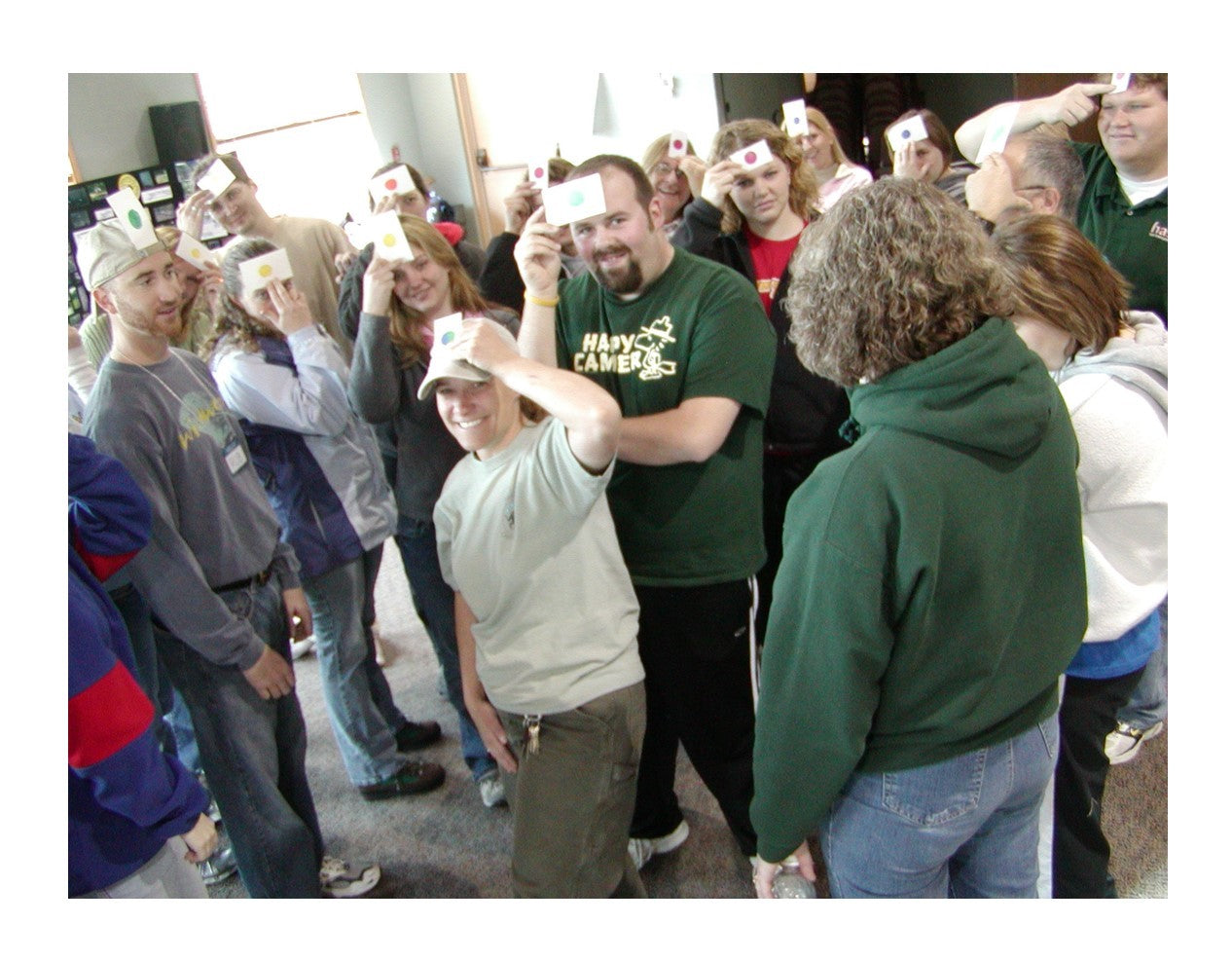 A collection of laminated colored dot cards in various solid and mixed colors, arranged with a mesh envelope.