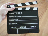 A classic black and white movie clapboard used for group reflection and storytelling activities.